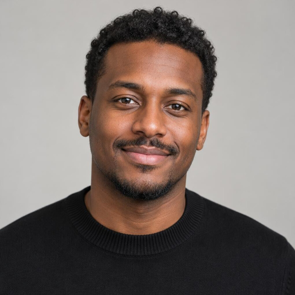 Portrait of a young man with curly dark hair and a relaxed smile